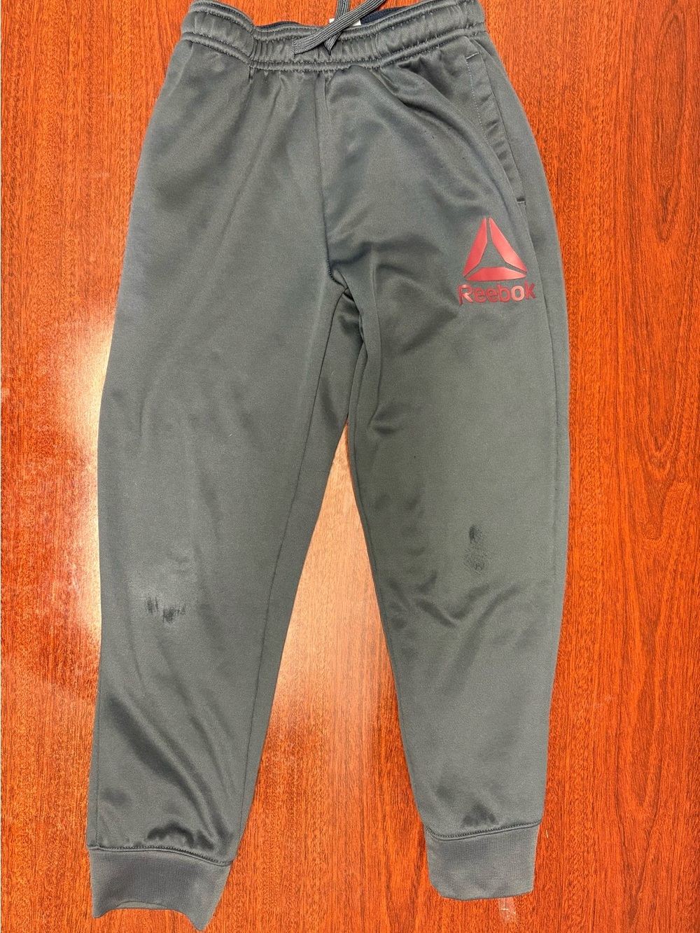 Reebok Kids dark gray Track Pants with burgundy Reebok logo. Size 8